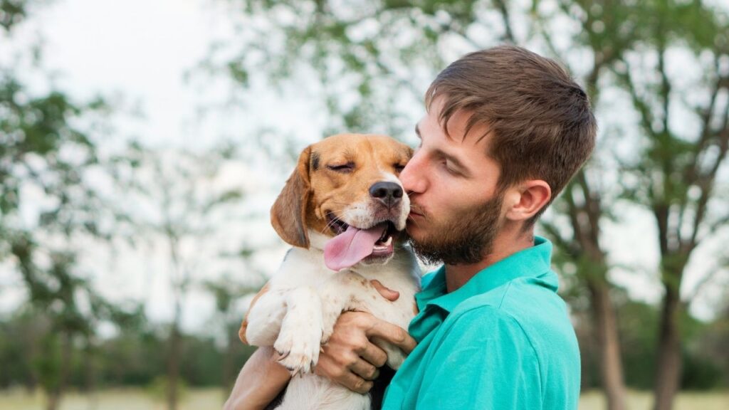 guy kissing dog