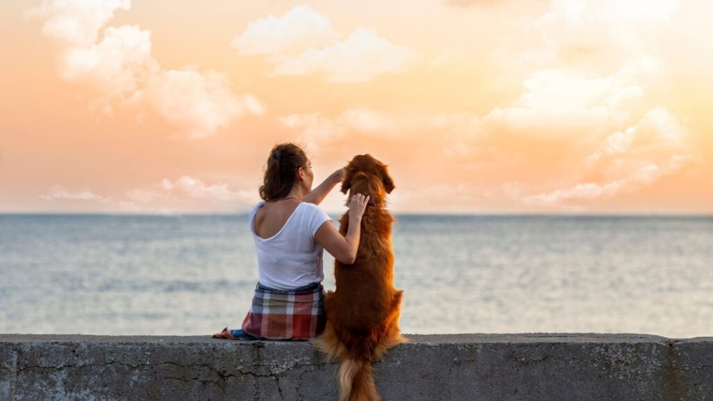 woman with dog at beach