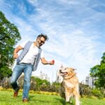 guy sitting with emotional support doggie