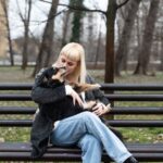 sitting with emotional support dog in park